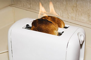 Picture of a toaster on fire demonstrating product liability